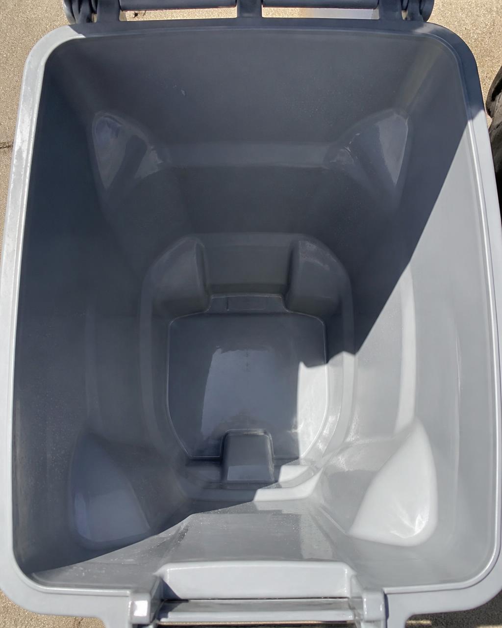 Inside of the same trash can spotless after a high-pressure clean